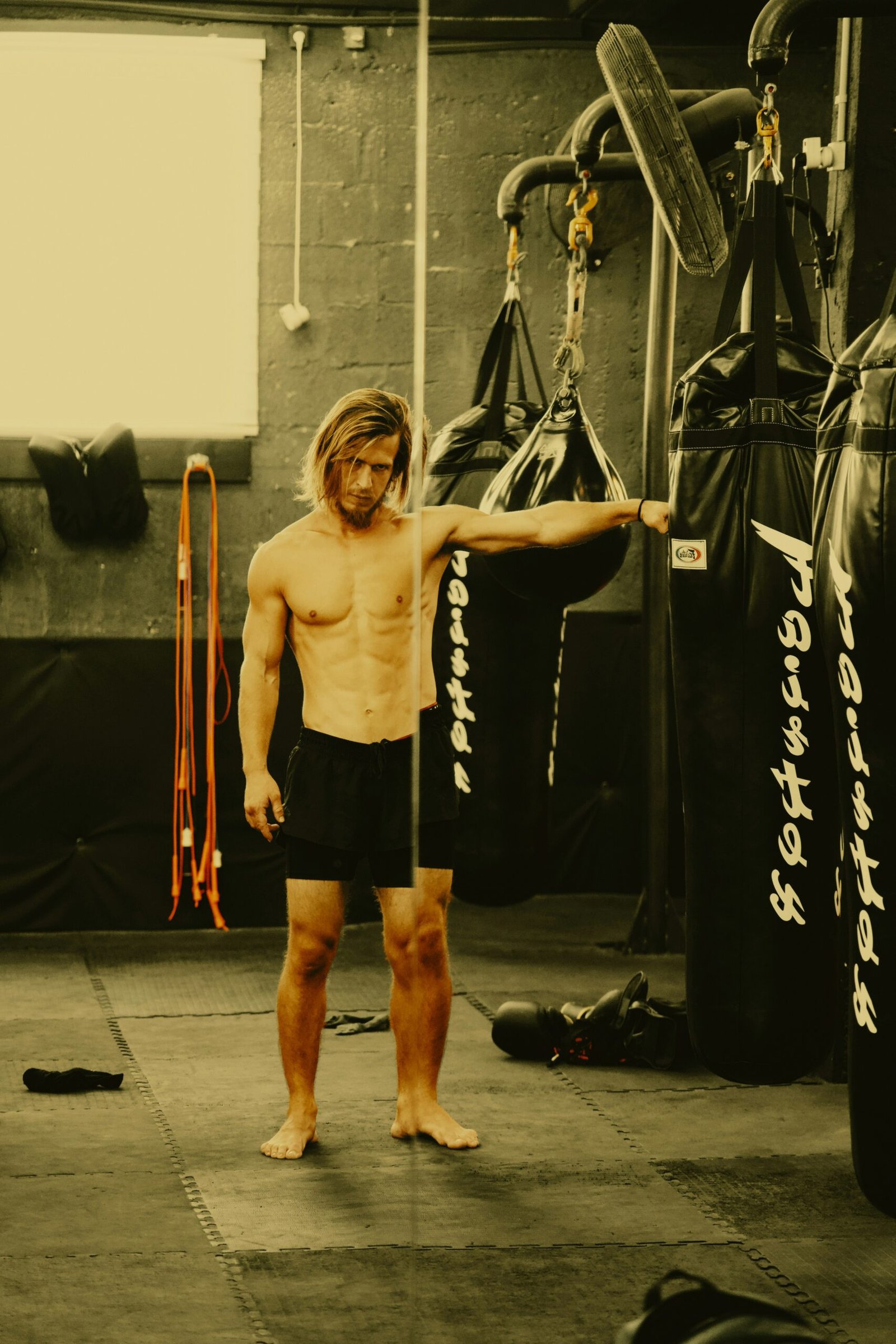 A man standing in front of a punching bag