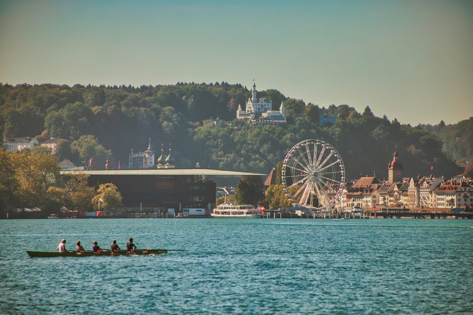 a group of people rowing a boat on a lake