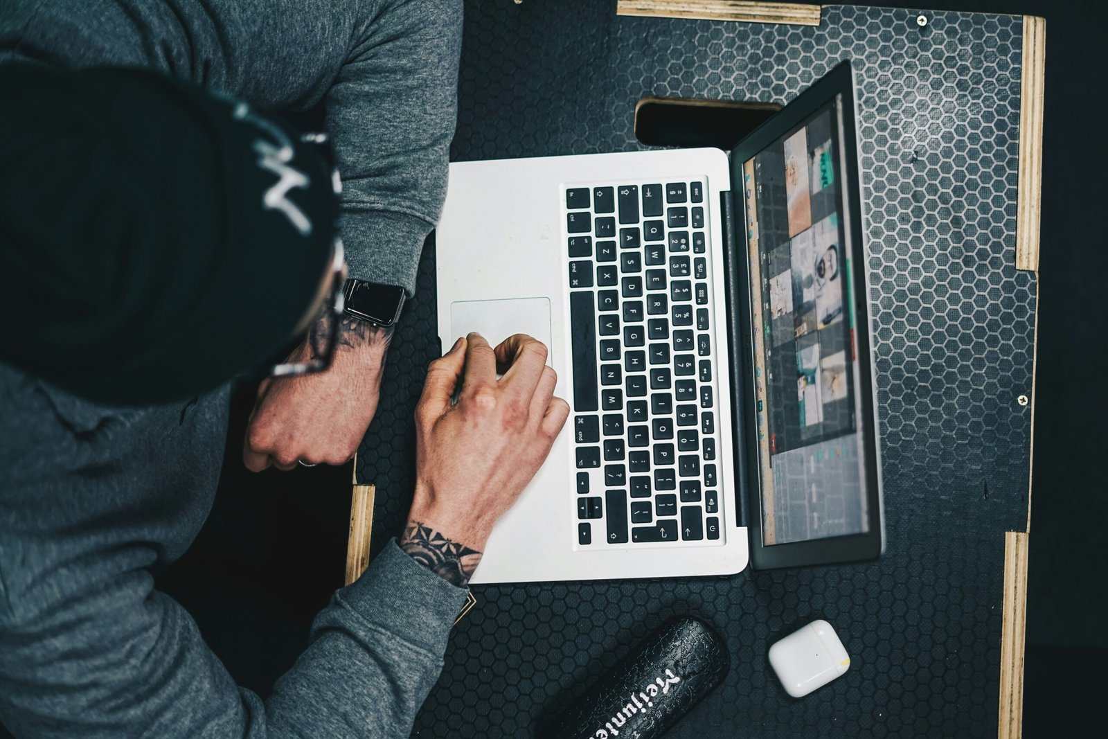 a man sitting at a desk using a laptop computer