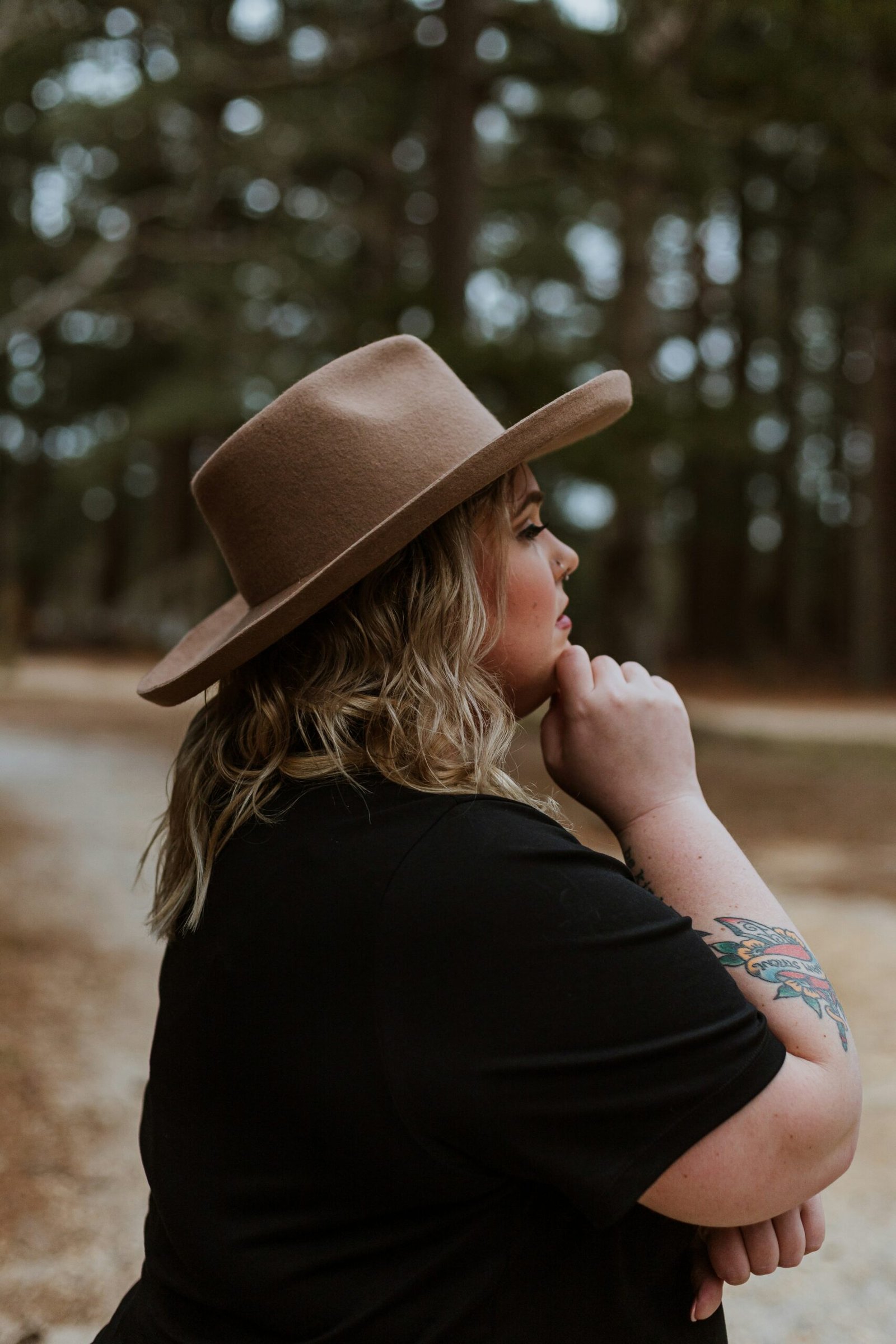 woman in black shirt wearing brown cowboy hat